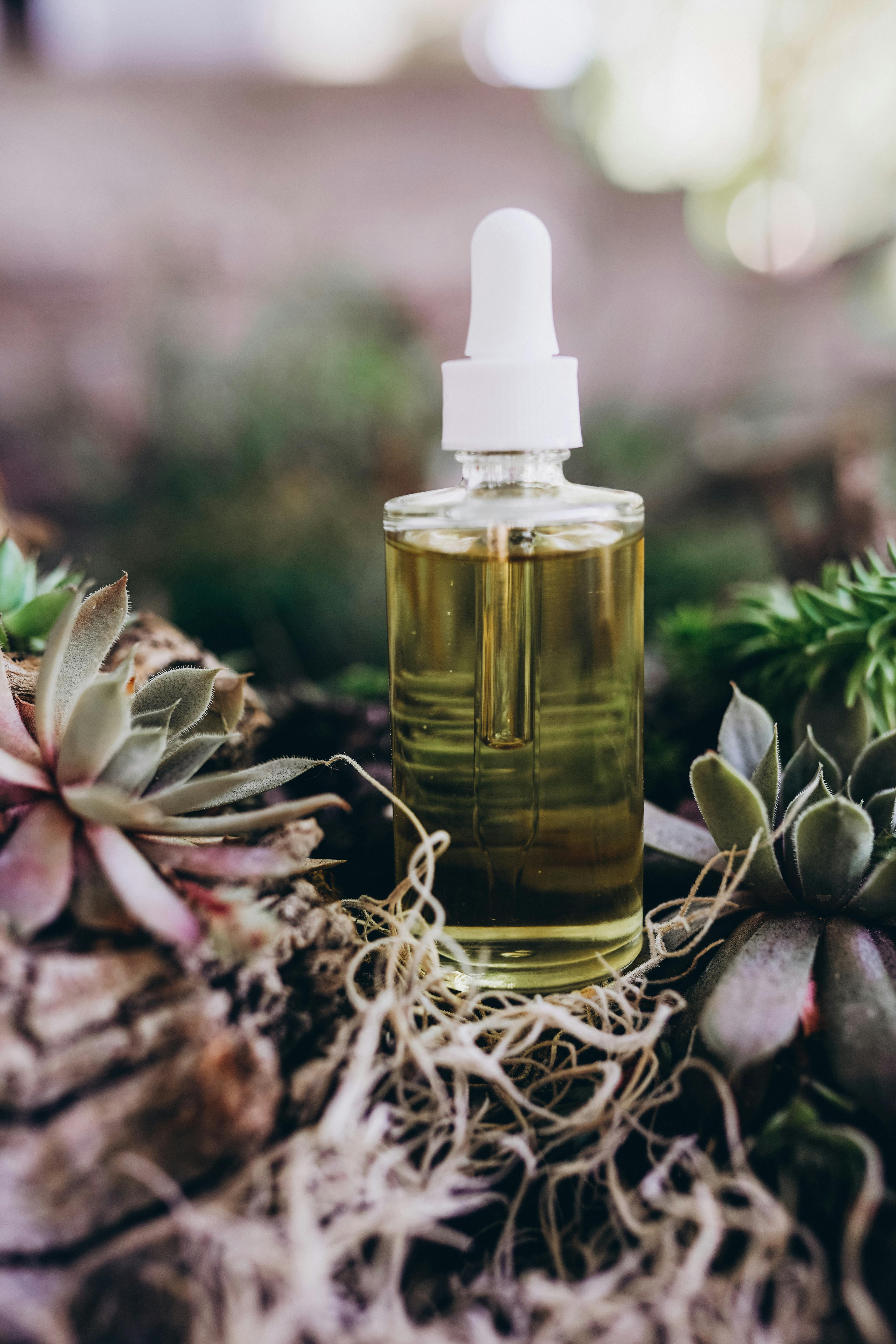 Rosemary oil bottle with herbs